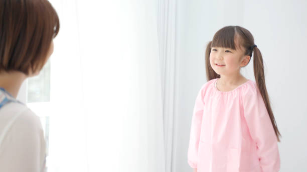 istock young asian girl playing with childminder 1321038421