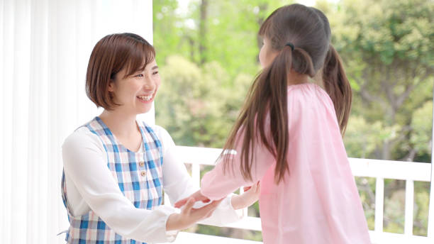 istock young asian girl playing with childminder 1321038435