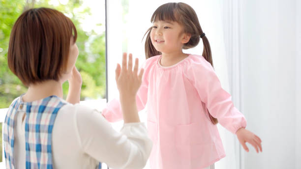 istock young asian girl playing with childminder 1321038442