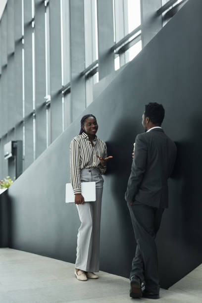 istock Two Elegant Business People Chatting 1321041744