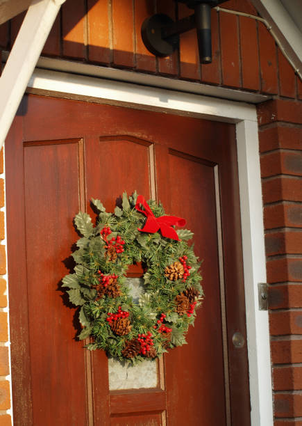istock Christmas wreath decoration on wooden front door 1321042443