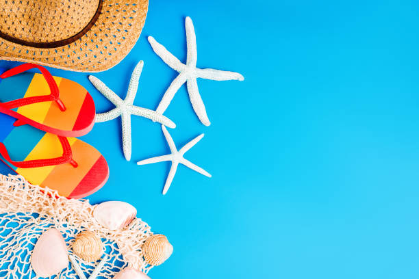 istock Summer background. Vacation concept, summer. Seashells with starfish on a blue background.  Beach accessories for relaxation. View from above. Copy space. Place for your text. 1321043484