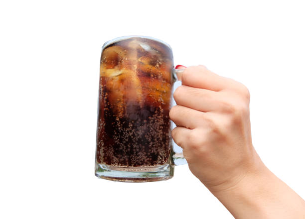 istock Woman hand holding fresh cola with ice cubes 1321045461