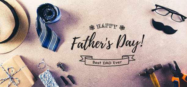 istock Happy Father's Day decoration with beautiful tie with mustache, hand tools, glasses, gift box and hat on dark stone background, vintage style. 1321047537