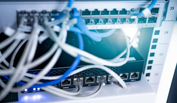 istock Network switch and ethernet cable in data center. Wifi plug of internet router for computer. Network hub. Communication networking wireless. Network switch and ethernet optic fiber cable in the rack. 1321047610