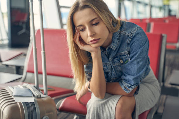 istock Bored blonde woman waiting for the boarding 1321050340