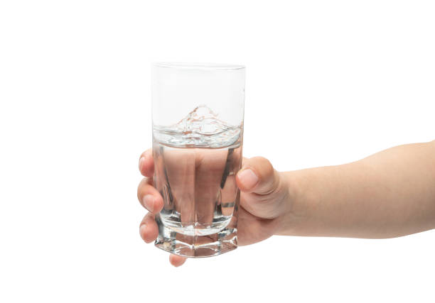 istock male hand holding glass cup. Isolated on white background. 1321050427