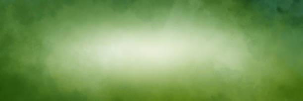 istock Green background with soft watercolor texture border and bright white center, elegant green Christmas paper 1321052384