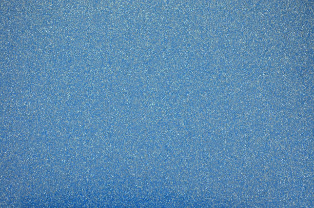 Dark bluish surface with small shiny blotches and vignetting around the edges.