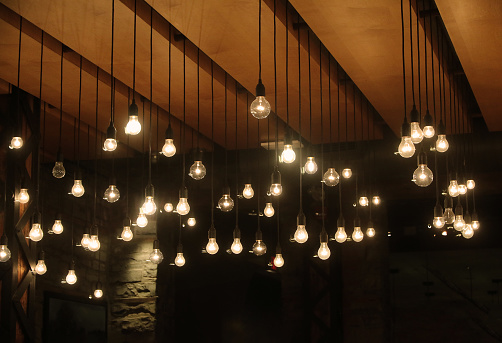 Illuminated bulbs hanging in a modern loft space