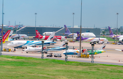 SAMUT PRAKAN, THAILAND-MAY 15, 2021 : Cargo aircraft parked at airfield in the airport near AOT office building. Cargo plane of Vietjet Air, Bangkok Airways, Thai Smile, and Thai Airways. Air logistic