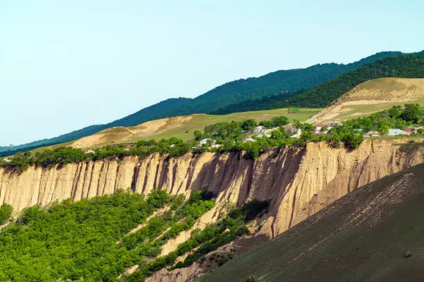 Photo of Village with houses on the edge of wooded hills