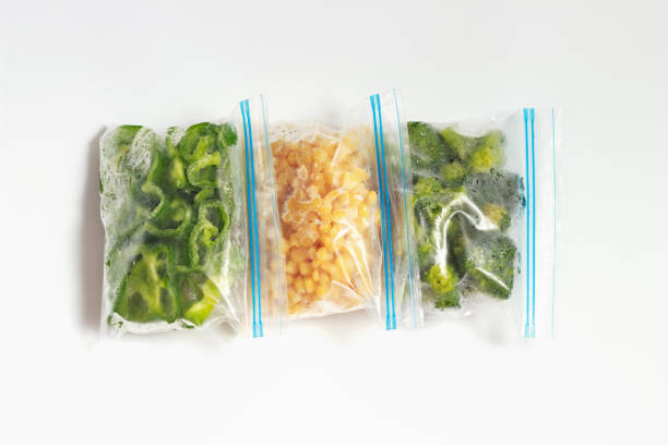 istock Three packages with frozen vegetables on white background, top view. 1321061712