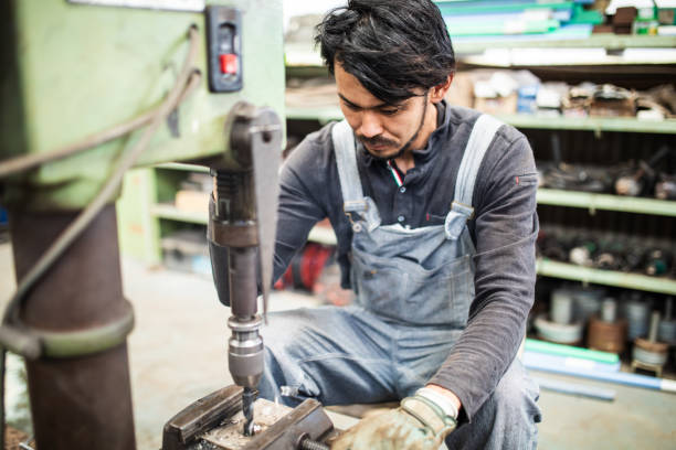 istock Japanese steel factory worker man using a drill machine 1321063709