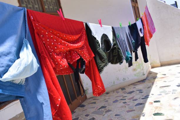 istock Hanging lots of clothes for drying at home 1321063863