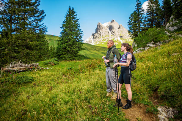 Beautiful hiker woman and middle aged man during some free time and fresh air outdoors whilst on a european staycation