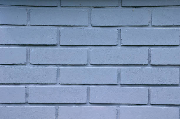 istock brick wall from tiling without joints. very smooth stacked red wall. very nicely stacked with black pieces on the corners of a house building, white paint 1321069457