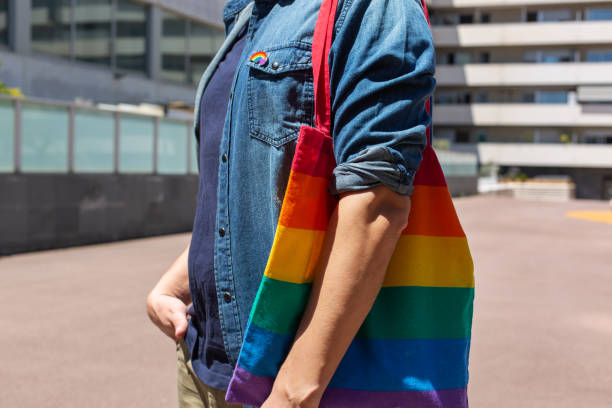 istock Man with rainbow reusable bag and lgbt badge, pride month 1321071246