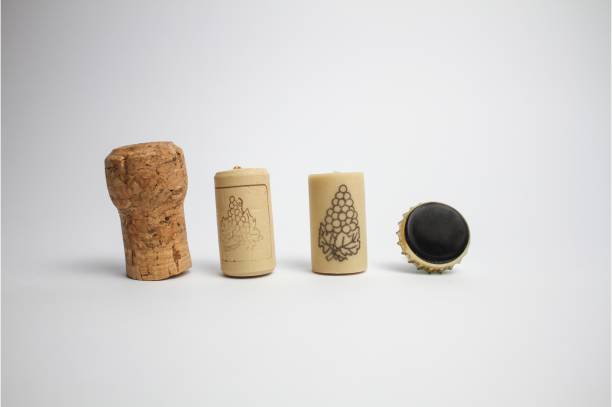 istock Three wine corks and a beer lid isolated on white background 1321071256