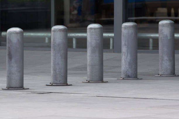 istock Stainless Steel bollards on concrete pavement. 1321072011