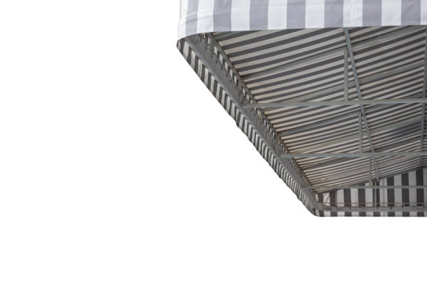 istock grey and white striped awning with beach background. 1321072019