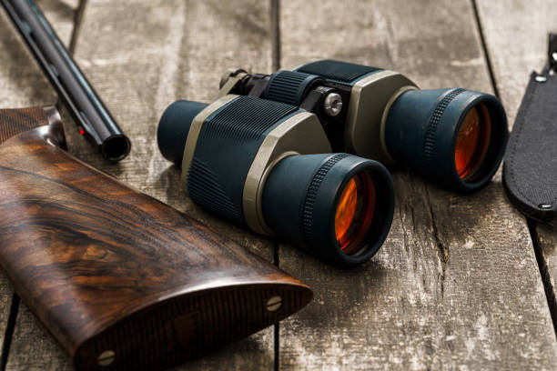 istock Hunting equipment binoculars on wooden background close up 1321073432