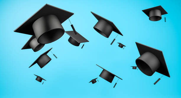 istock Bachelor graduation caps celebrate mock up flying in the blue sky background. 1321073536