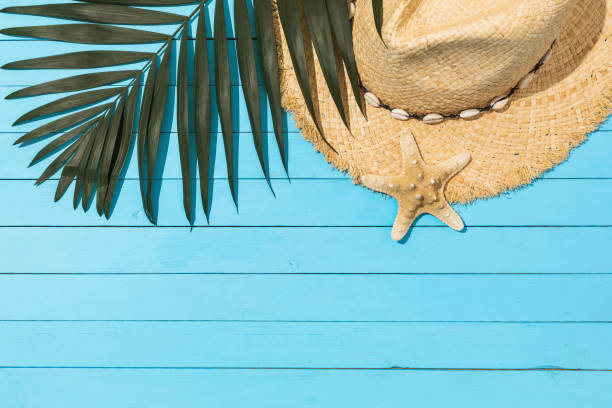 istock Chico leaf, hat and starfish on a light blue wooden background with copy space 1321073592