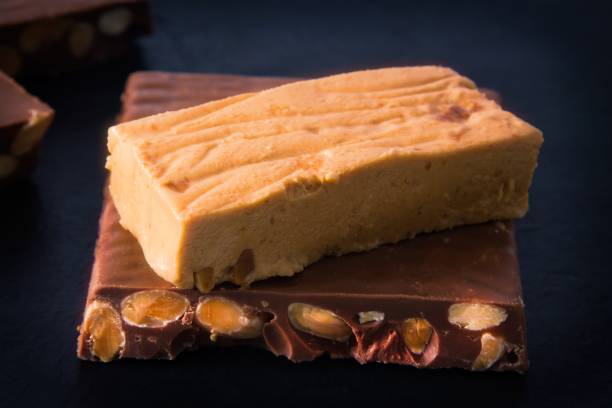 istock Almond nougat, typical Christmas dessert on black background 1321074285