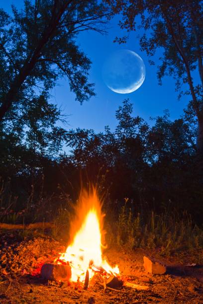 istock camp fite and a moon 1321074714