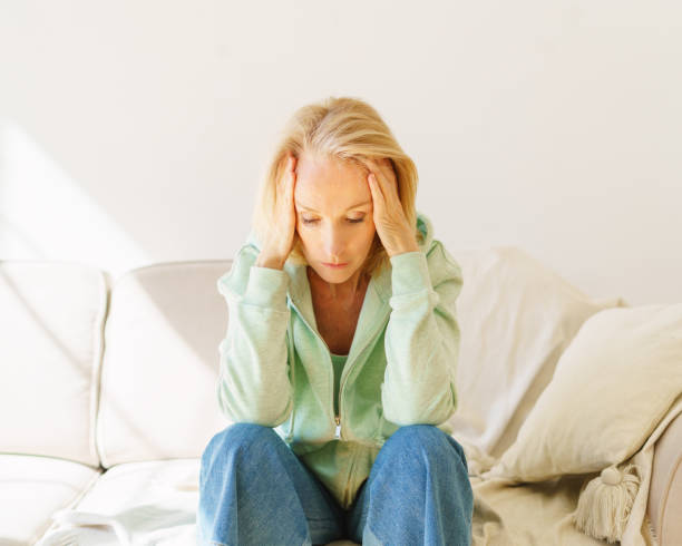 istock Melancholic retired woman feeling upset and depressed while sitting on sofa at home 1321075584