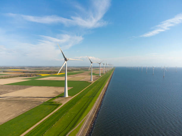 istock Wind turbines on a levee and offshore during springtime seen from above 1321076965
