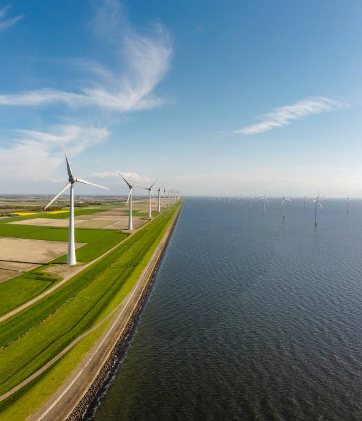 istock Wind turbines on a levee and offshore during springtime seen from above 1321076995