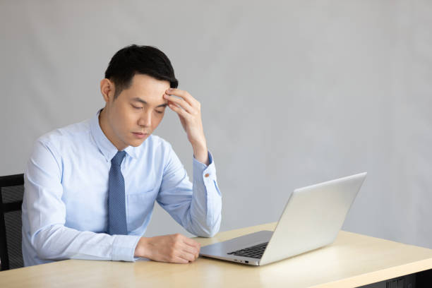 istock stressed asian businessman feeling sick and tried in office 1321078236