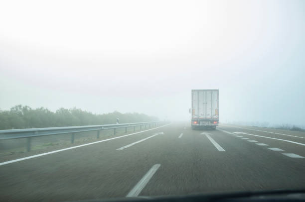istock Driving behind a truck under dense fog 1321078315
