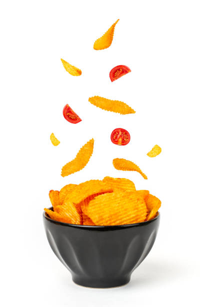 istock Potato chips in bowl and falling into bowl 1321079389