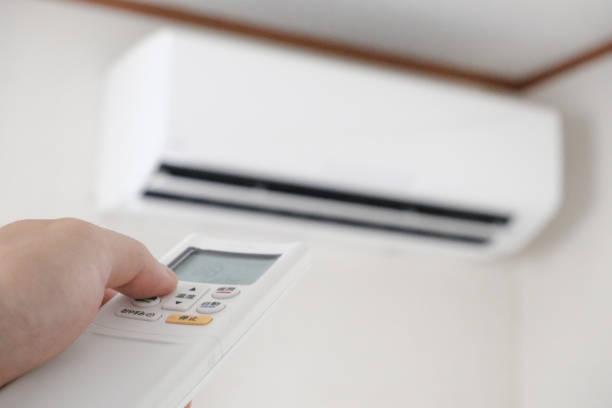 istock Image of turning on the air conditioner with a remote control 1321080193