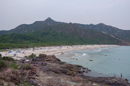 Tourists camp on the beach of Tai Long Wan. once remote and secluded, the pandemic has changed it all. Without the ability to fly away for holidays without staying in quarantine for 3 weeks on return, it has become of the most popular destinations in Hong Kong now.