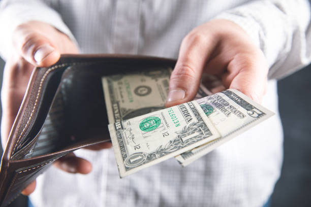 istock man withdraws money from wallet 1321081818