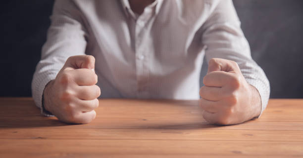 istock male fists on the table 1321081871