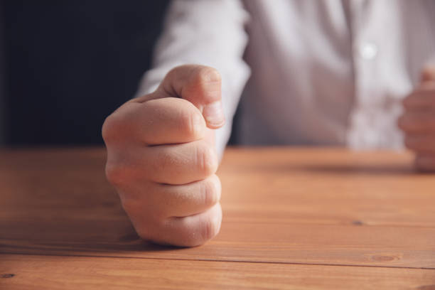 istock male fists on the table 1321081874
