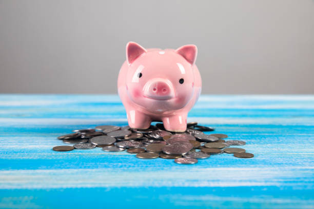 istock piggy bank on a wooden table 1321081944