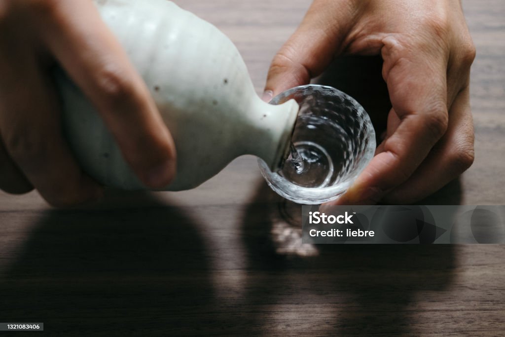 middle-aged man  drinking alcohol  by myself. Saki Stock Photo