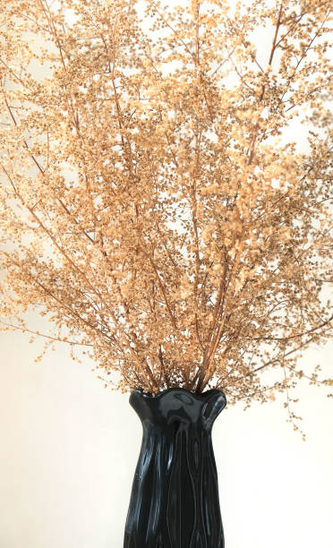 istock Black vase with dried flowers on  neutral background. 1321083447