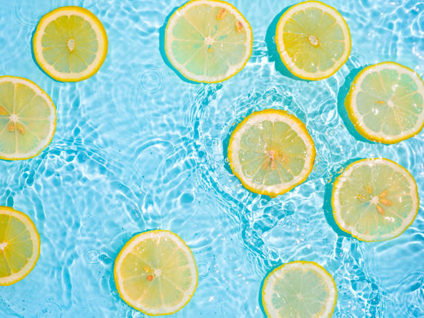 istock Lemon slices in clean transparent water, blue bg 1321084261