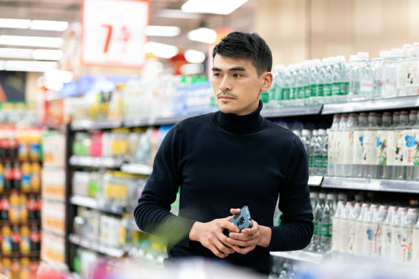 istock Asian young male customer in supermarket 1321087931