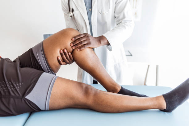 istock Close-up Of Therapist Doing Knee Massage 1321089003