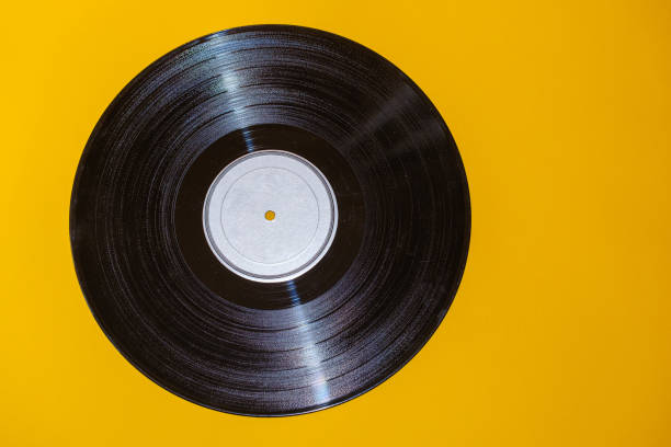 istock old vinyl record lies on yellow background 1321090382