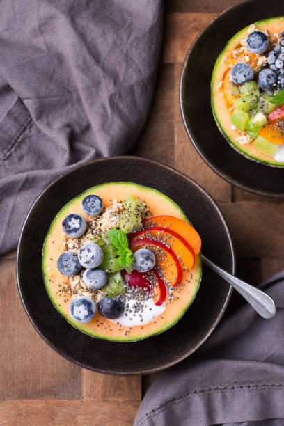 istock Fruit salad with yogurt in carved melon cantaloupe bowl 1321093068