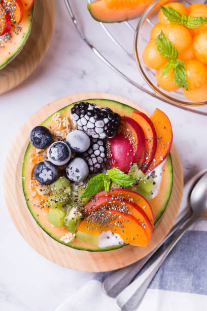 istock Fruit salad with yogurt in carved melon cantaloupe bowl 1321093140